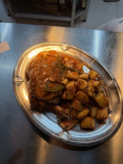 LAMB SHOULDER, SLOW-ROASTED IN AROMATIC HERBS WITH ROASTED ROSEMARY POTATOES